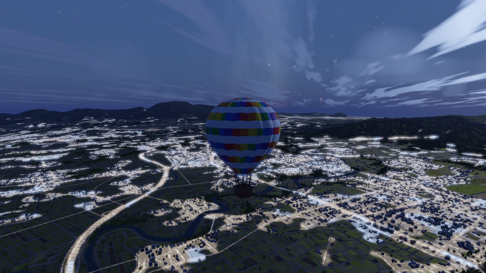 A balloon over the scattered lights of a town at night
