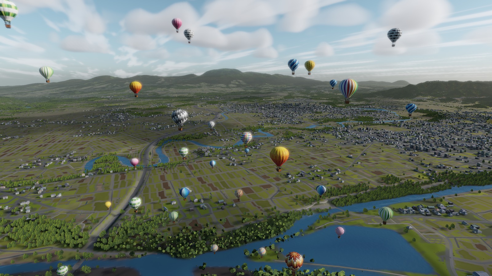 Balloons scattered across a wide river plain of fields and towns in the morning