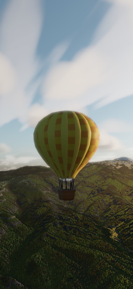 An olive and gold balloon crossing a steep forested ridge
