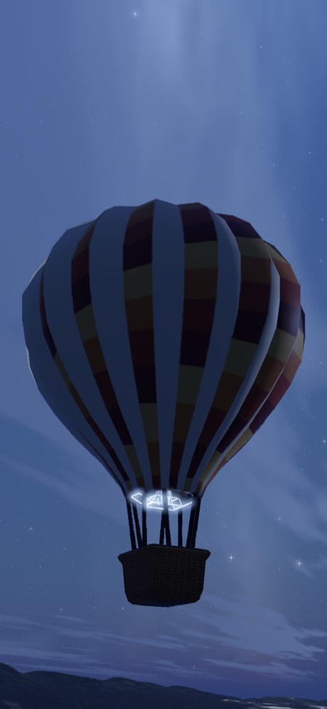 A dark chequered balloon lit from inside by its burner at night