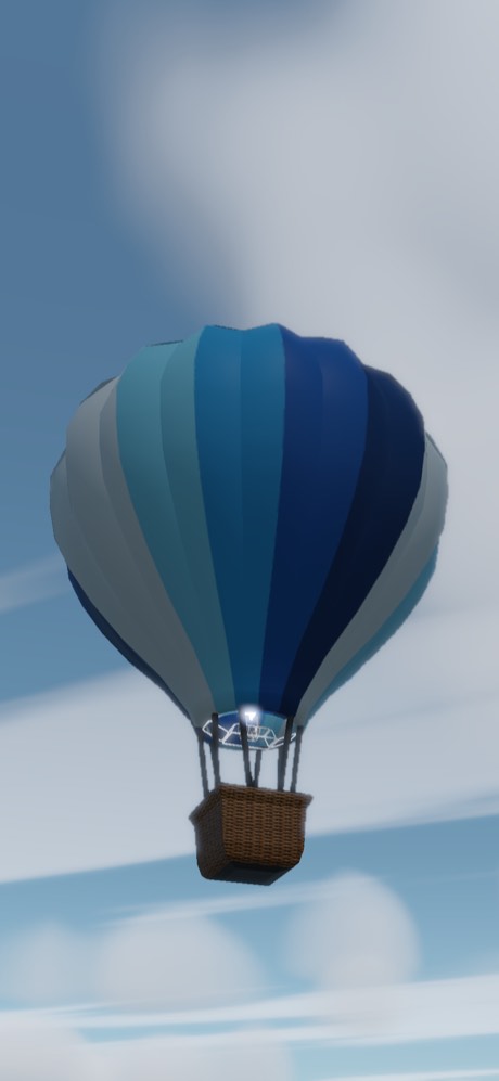 A balloon in graded blues and greys against a hazy midday sky